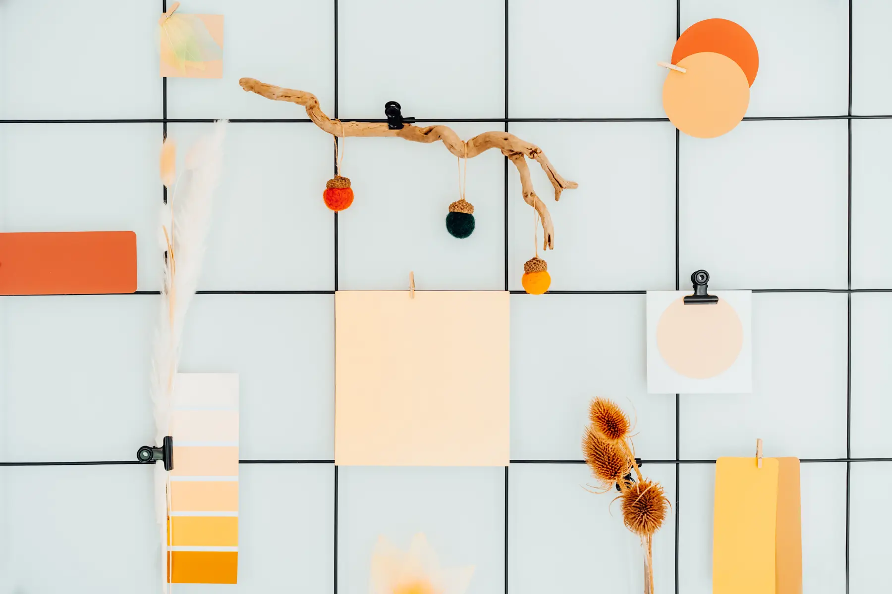 Swatches and paper pinned to a grid wall