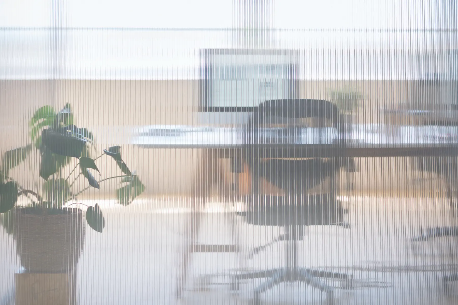 An office desk seen through fluted glass