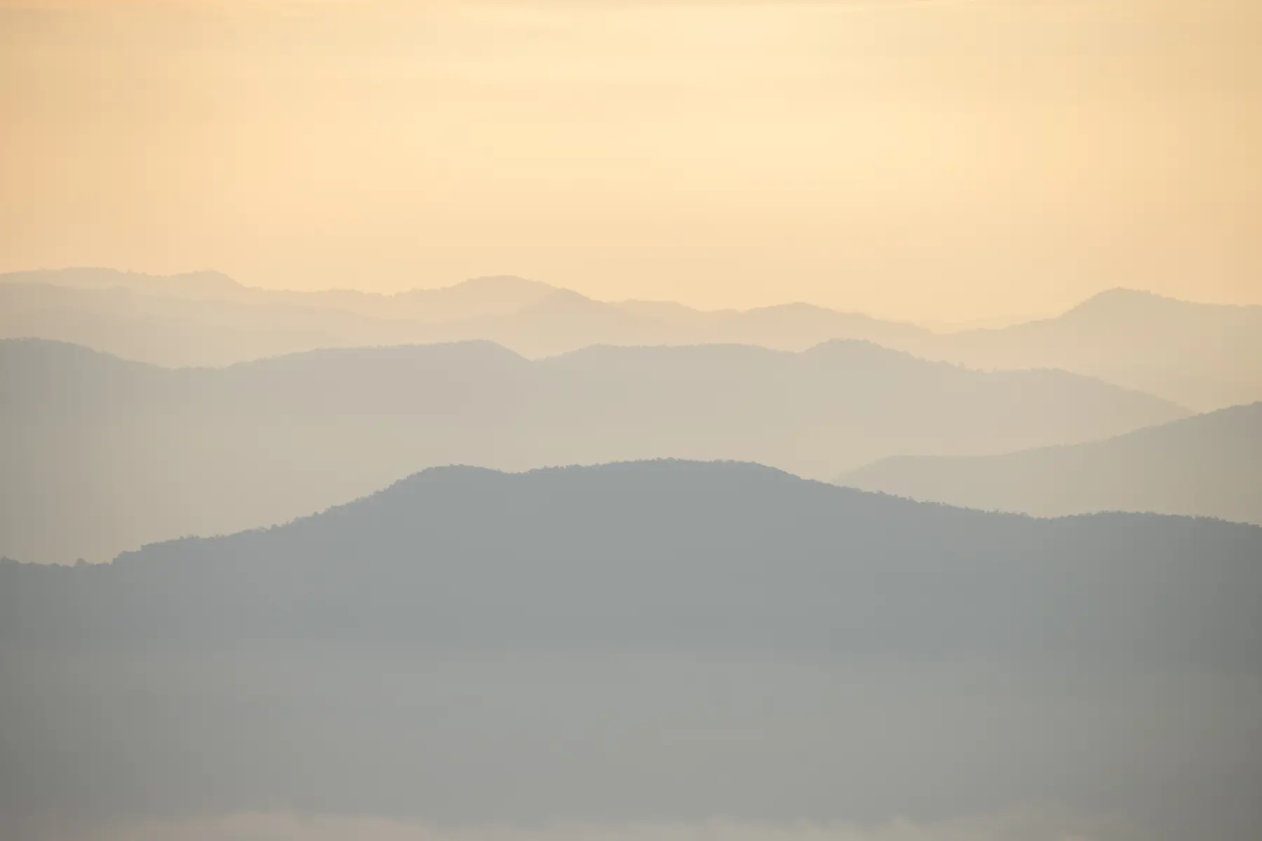 Mountain ranges in layers of haze at sunrise