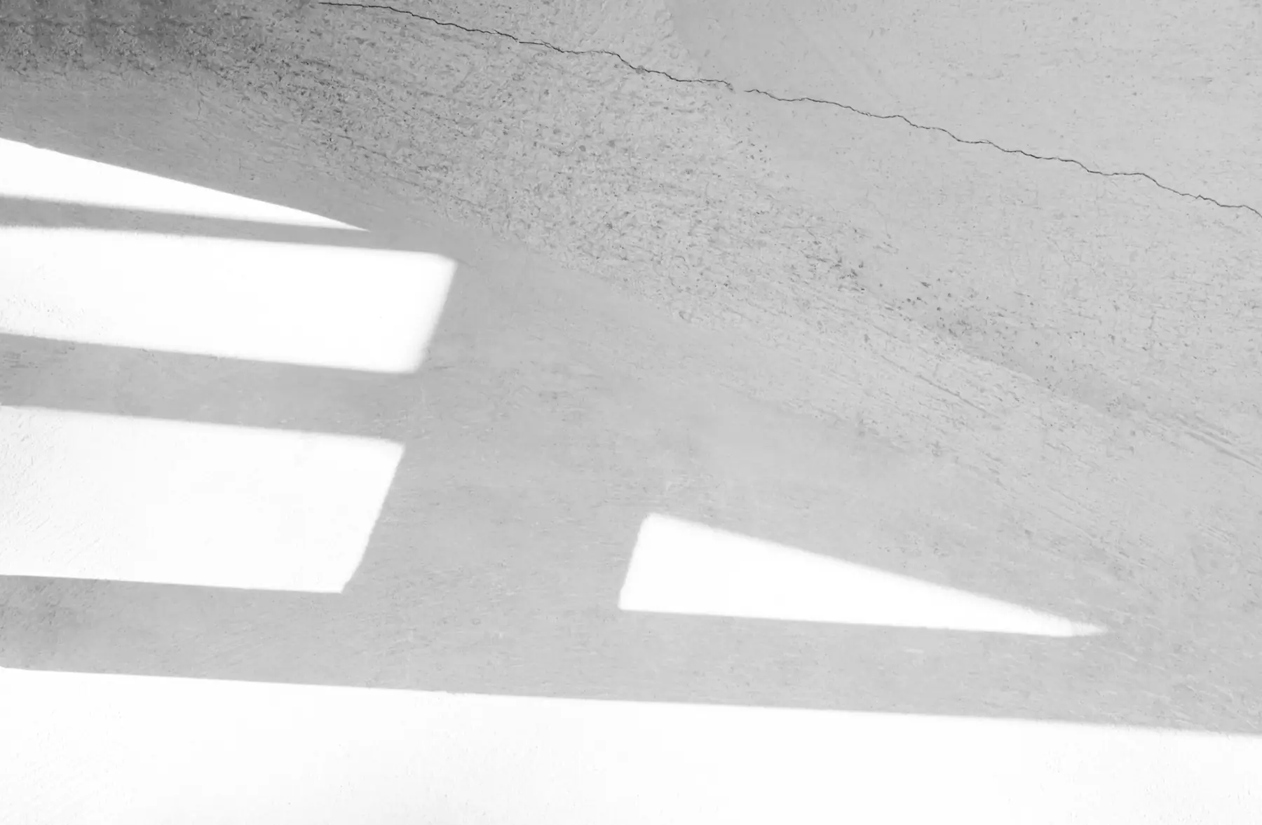 Light and shadow falling across a wall