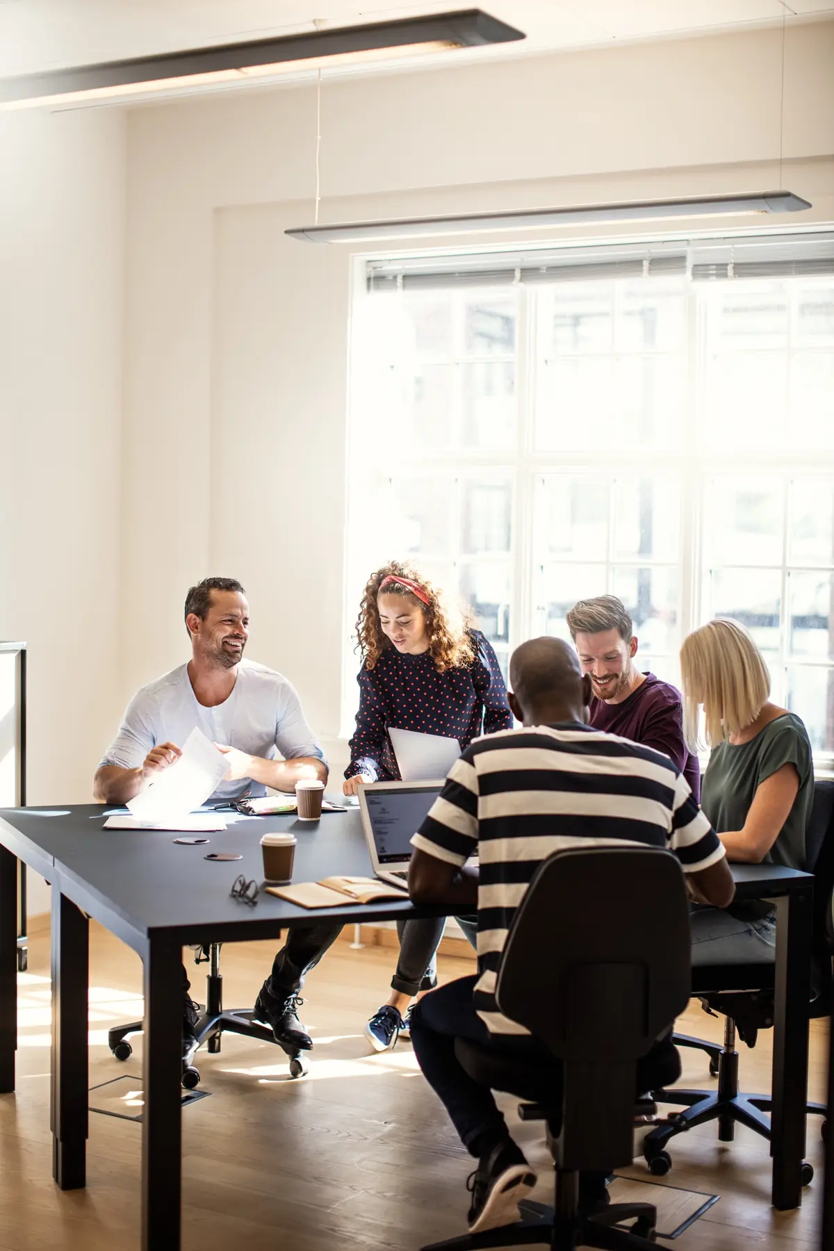 A team round a meeting table in a bright office
